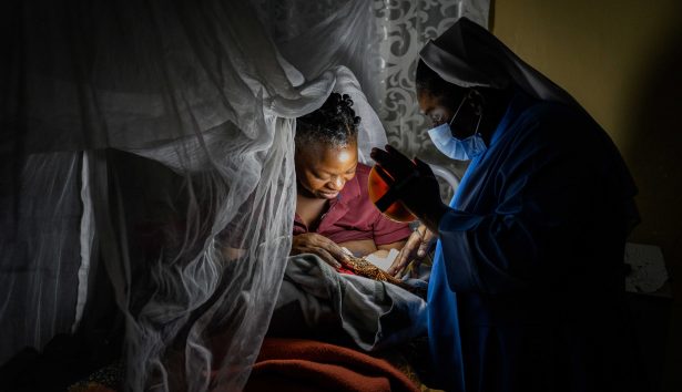 Sister Grace welcomes a newborn into the world with her solar light.