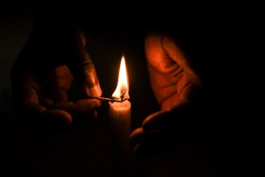 Candle flame in TA Kasakula's hands