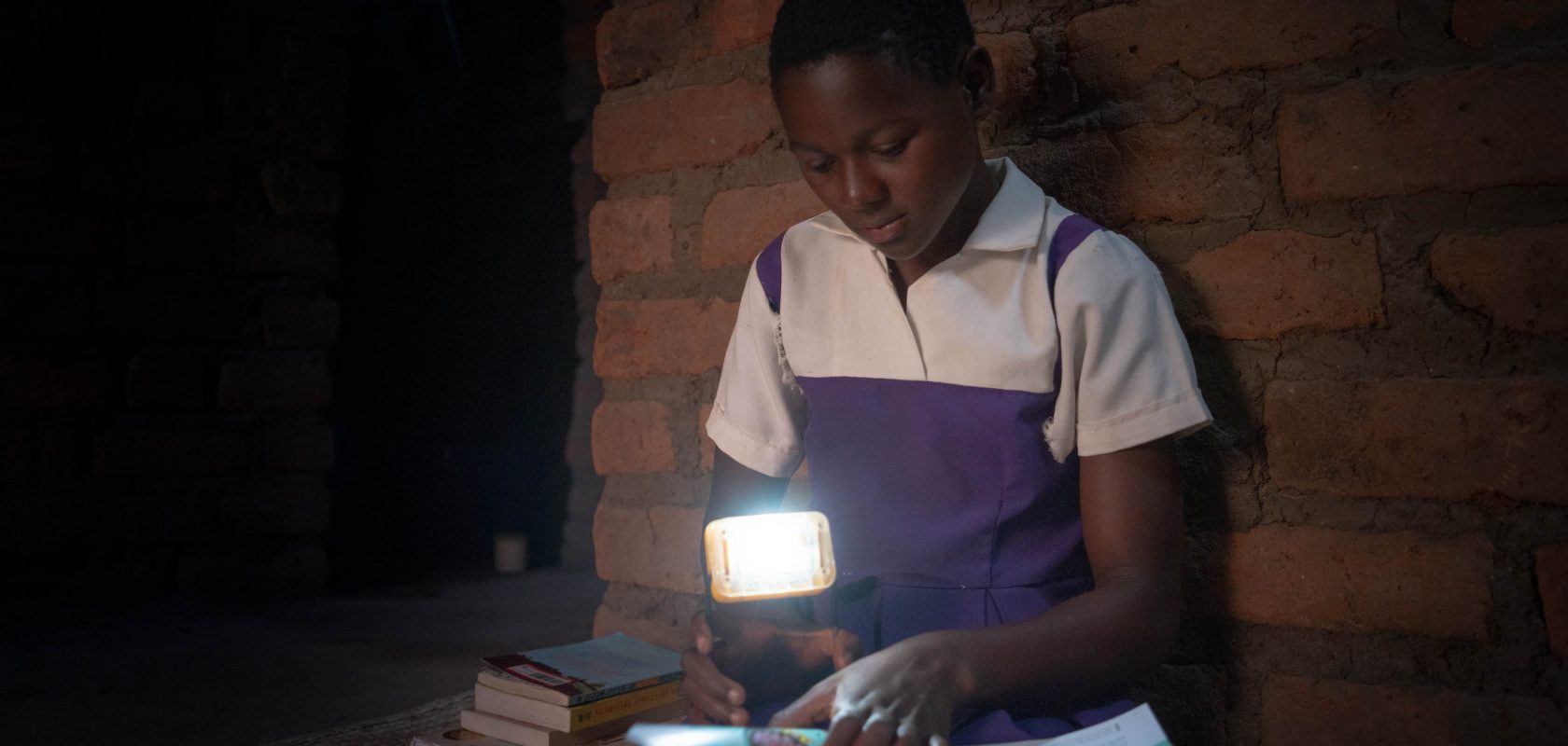 A girl reads by solar light.