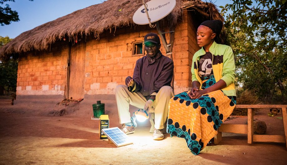 Penny demonstrating solar lights to a customer