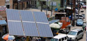 A solar panel with a busy street in the background