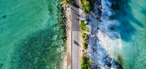 An aerial view of a road wedged between the ocean on both sides.