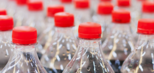 A row of plastic Coca-Cola bottles