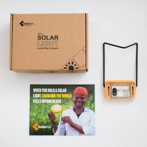 Flat lay of the SM200 and its packaging that tells the story of a solar light