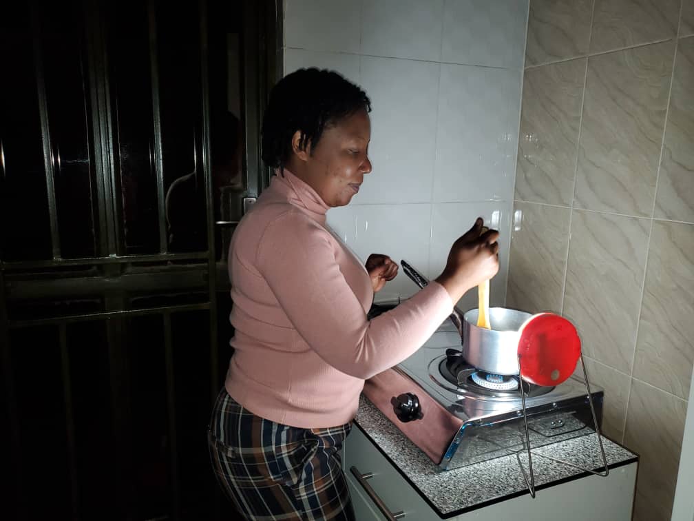 Woman cooking by a solar light.